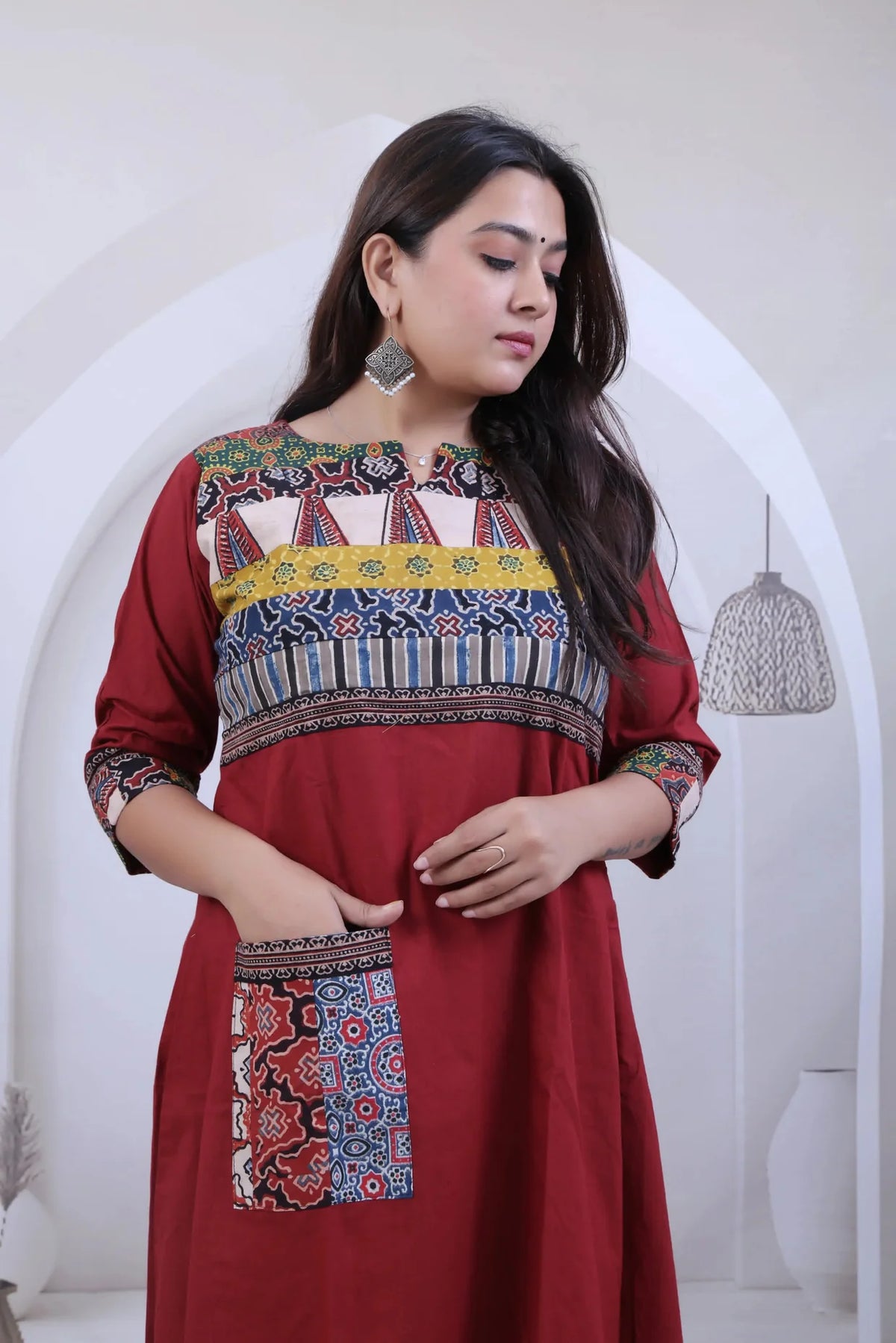 Saanvi Maroon Ajarakh Neck & Pocket A line Kurti